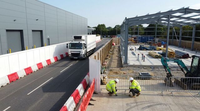 Separated extension works and a live delivery route beside an operating UK food factory