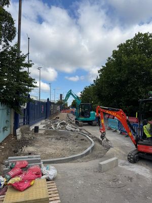Two excavators working along new kerb lines during Section 278 footway construction on River Road, Barking