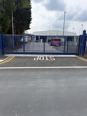 Fresh STOP road marking and white lining on the reinstated carriageway at the site access gates in Barking, East London